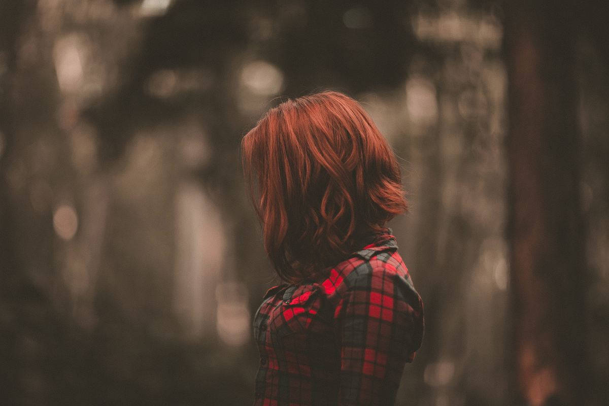 focused photo of a woman wearing red long-sleeved dress