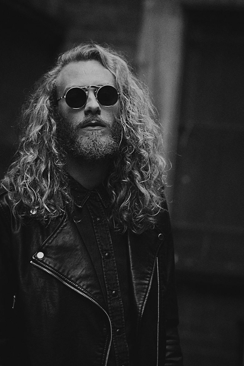 grayscale photo of man in leather jacket