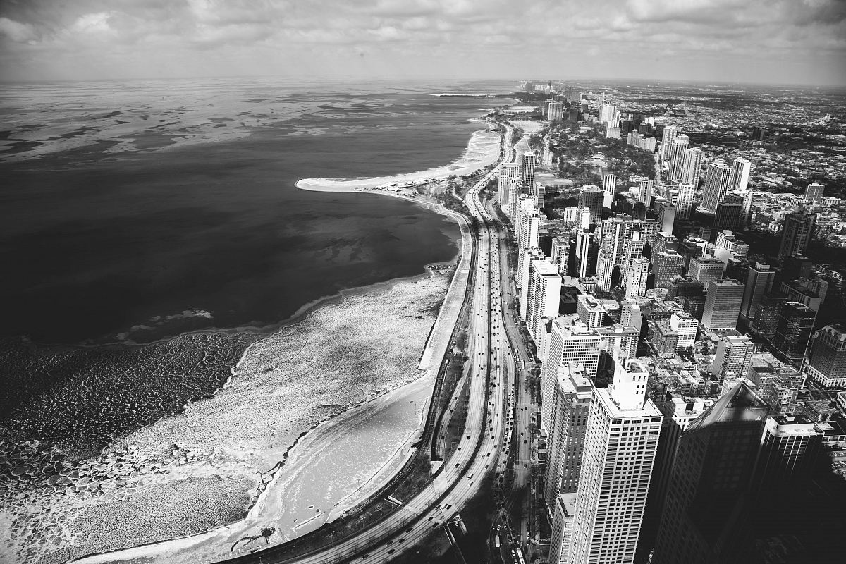 grayscale photography of buildings and body of water