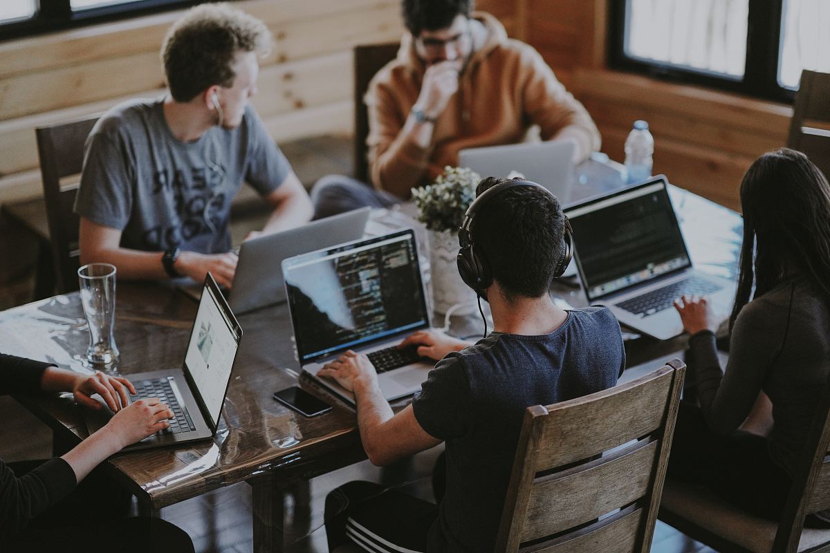 group of people using laptop computer