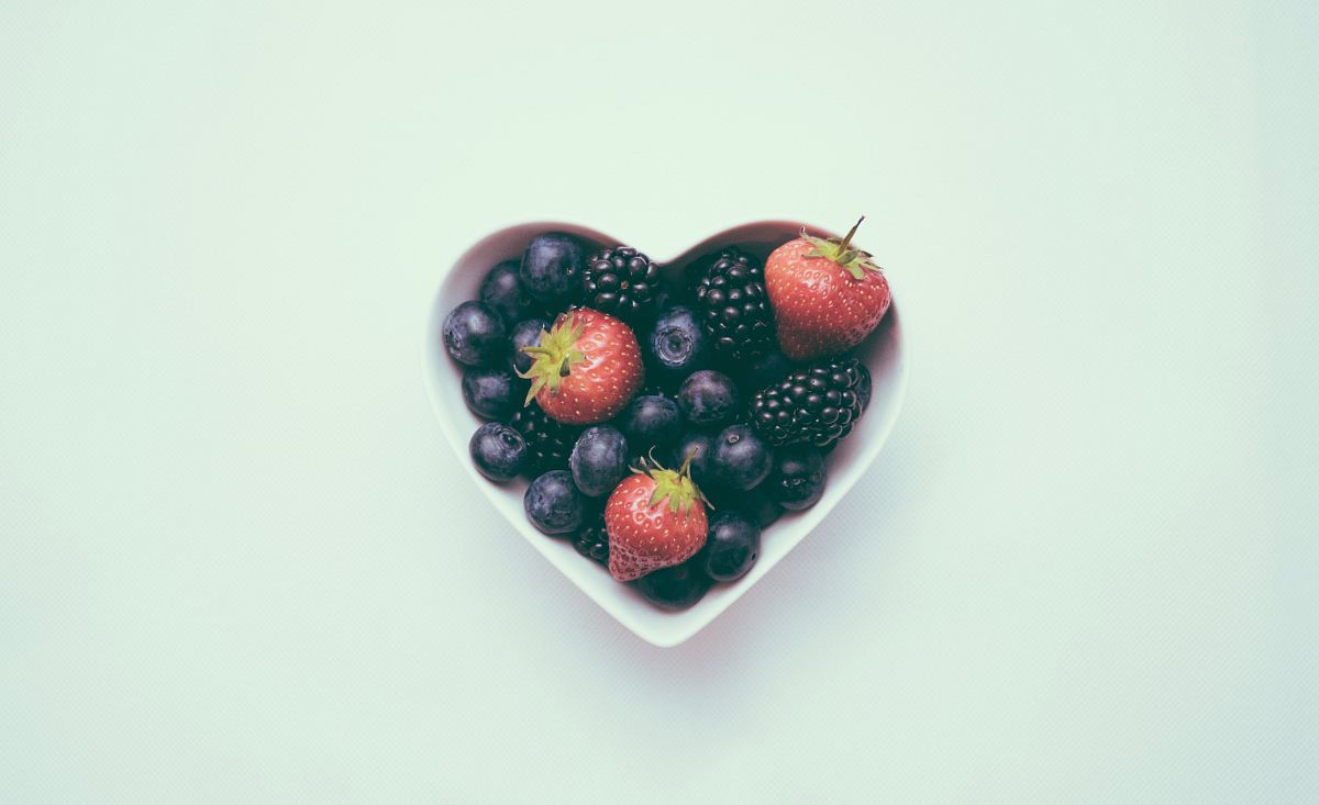 heart-shaped bowl with strawberries