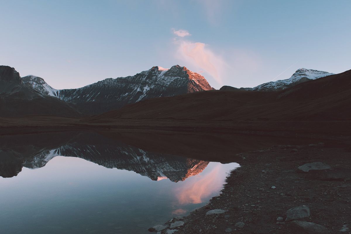 landscape photo of lake near gray mountains during daytime