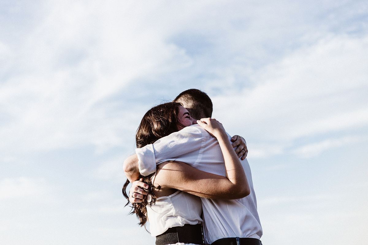 man and woman hugging each other photography