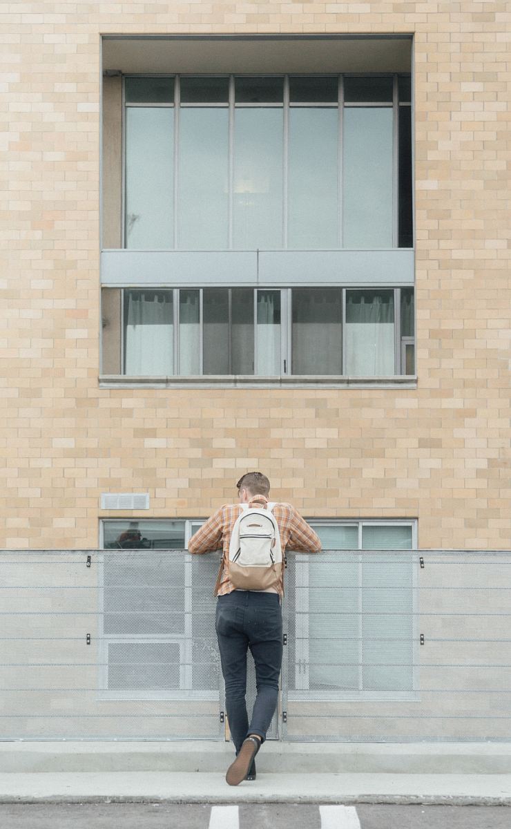 man standing in front of rail