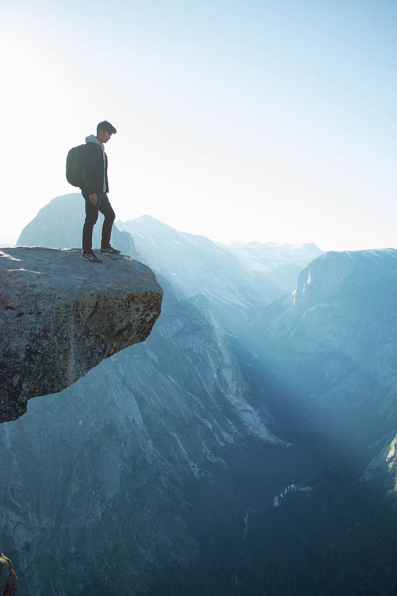 man standing on cliff