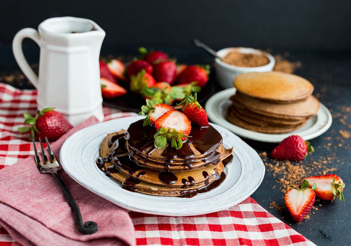 pancake with chocolate syrup on ceramic plate