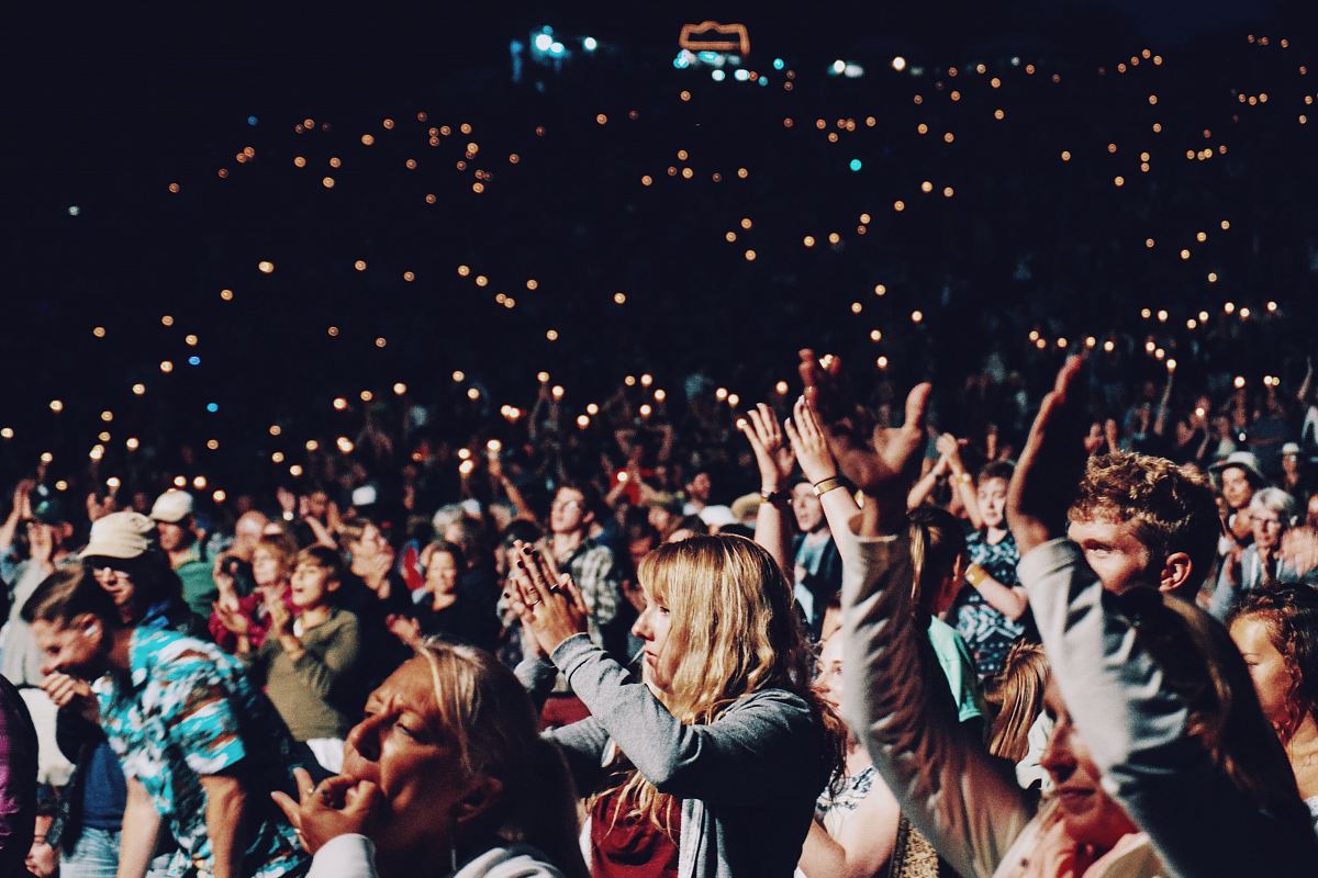 people racing smartphones on concert