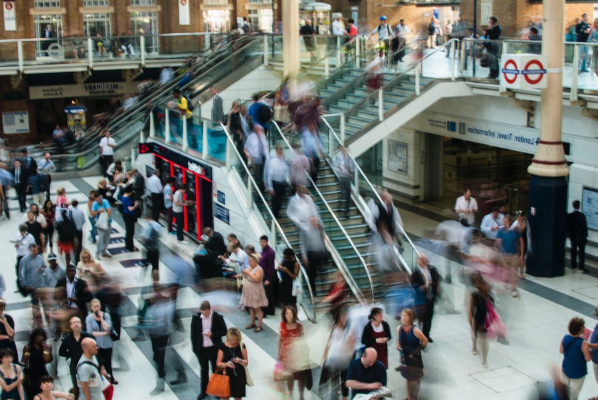 people standing and walking on stairs in mall