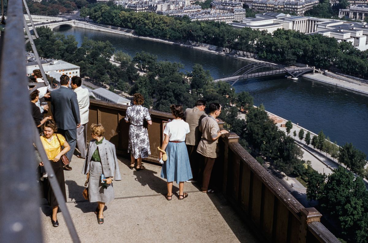 people standing on terrace with view of river