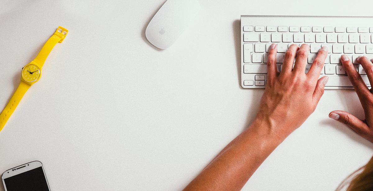 person typing on Apple Cordless Keyboard
