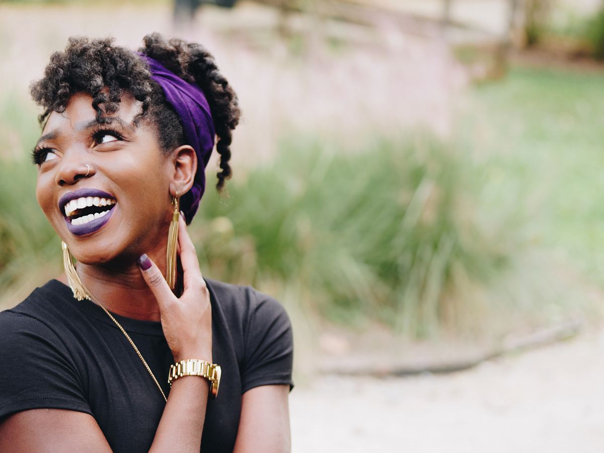 photo of woman wearing purple lipstick and black crew-neck shirt