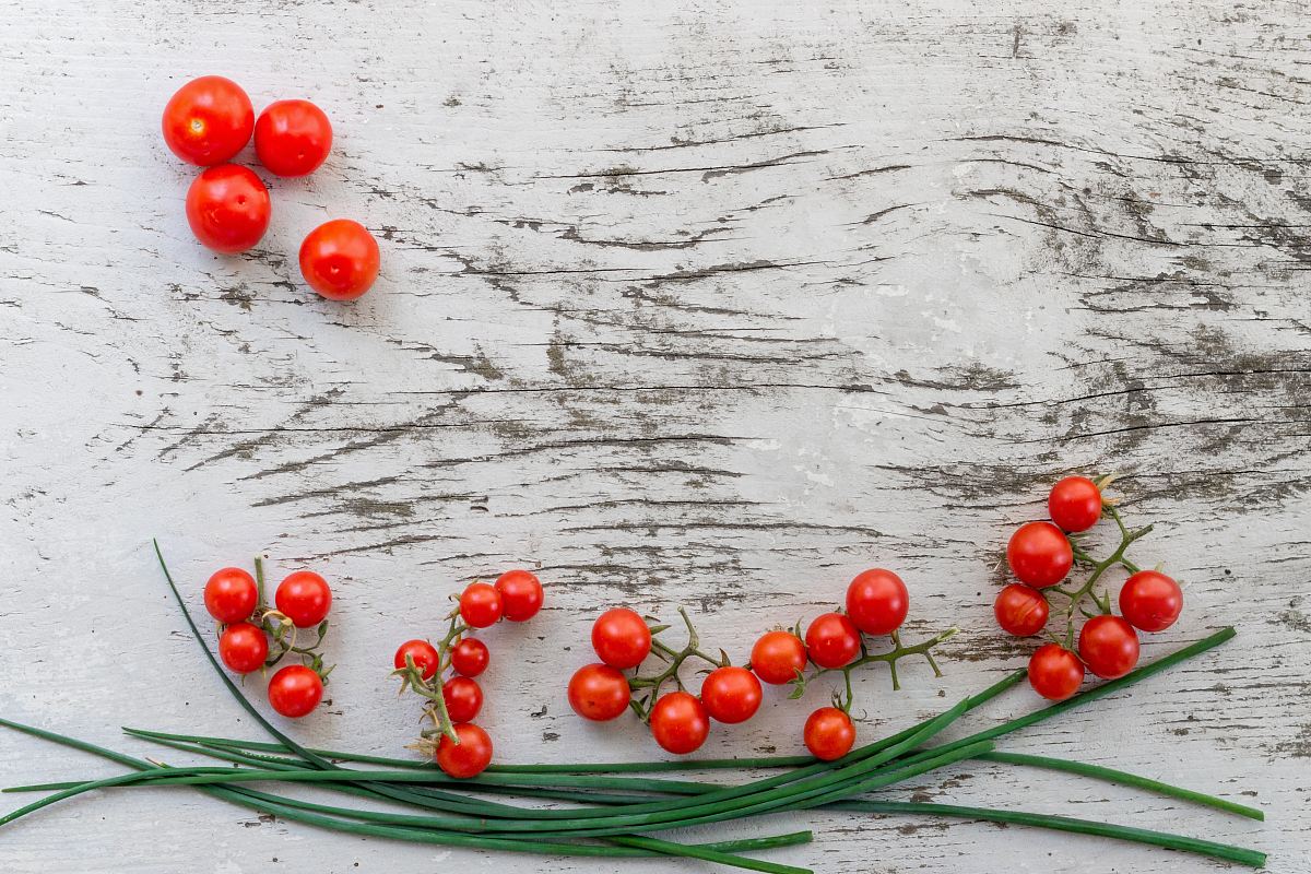 red citrus berries on gray surface