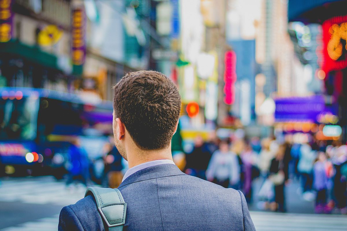 shallow focus photography of man in suit jacket's back