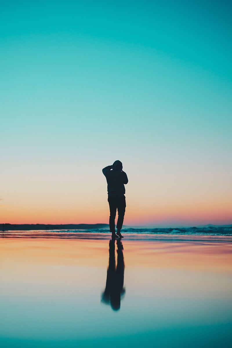 silhouette of person in seashore during daytime