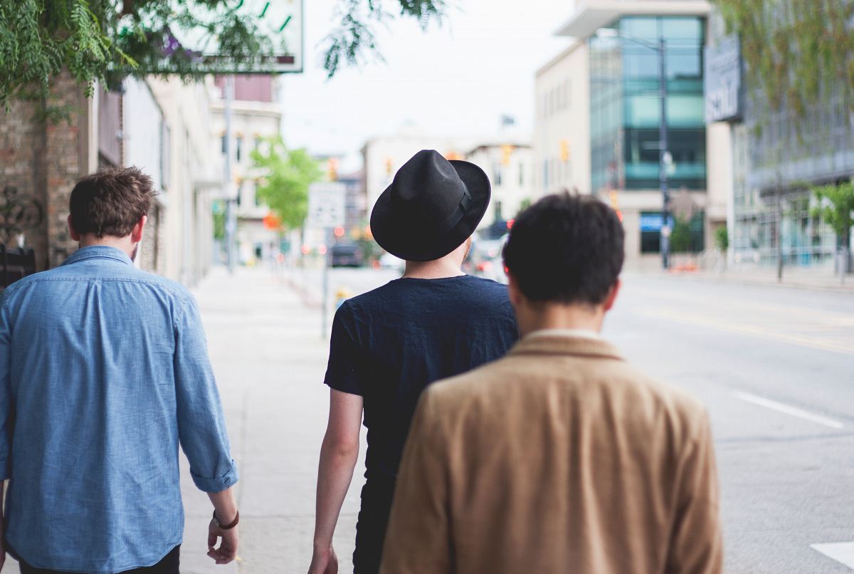 three men walking along the street