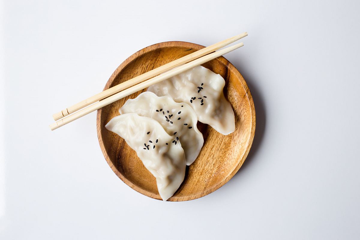 three white dimsum on brown bowl