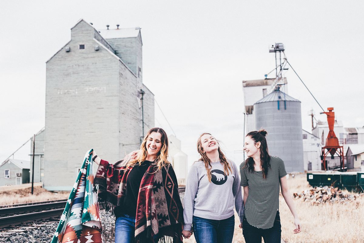 three women walking from industrial location