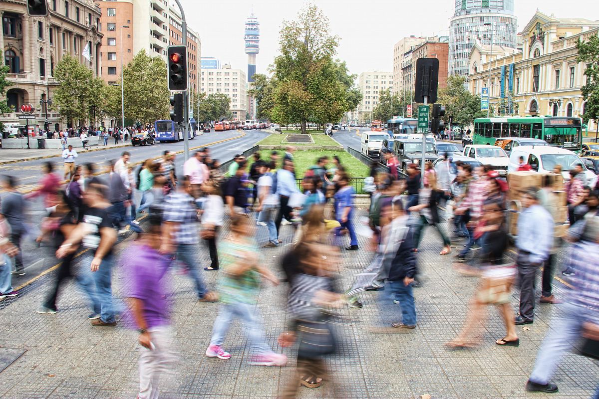 timelapse photo of people passing the street