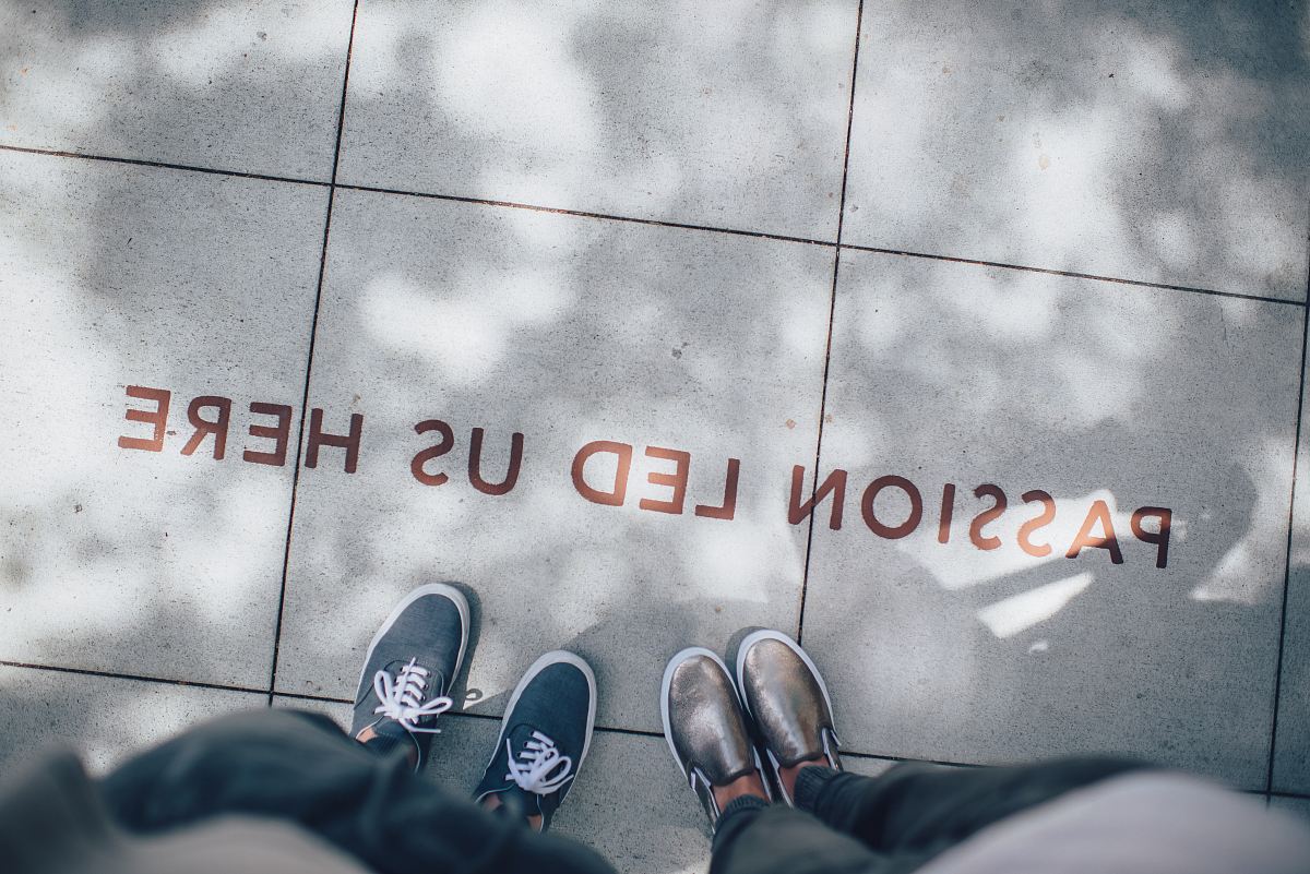 two person standing on gray tile paving