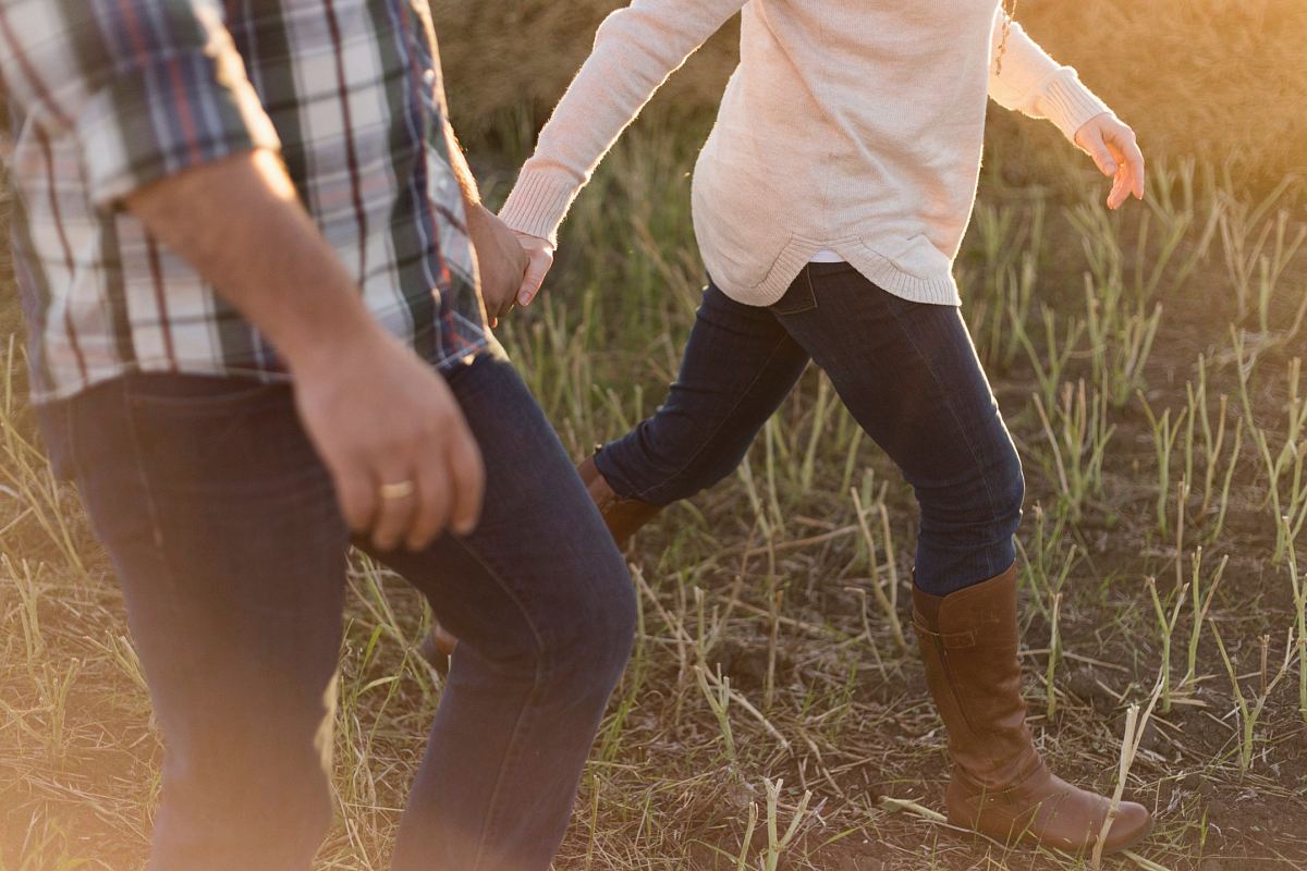 two person wearing denim pants on grass field
