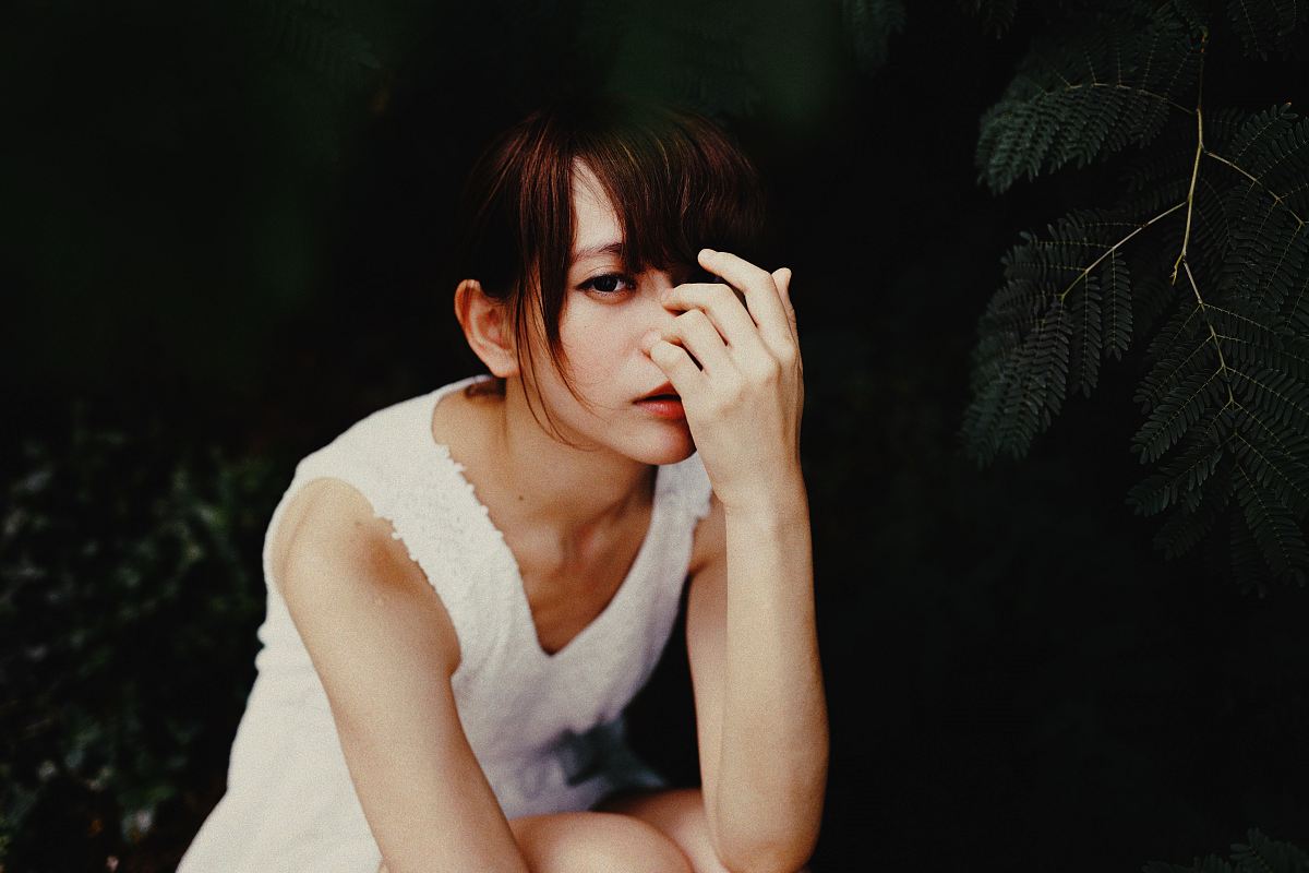 vignette photography of woman in white sleeveless dress