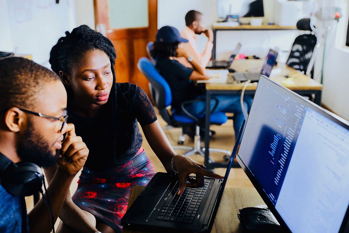 woman and man sitting in front of monitor