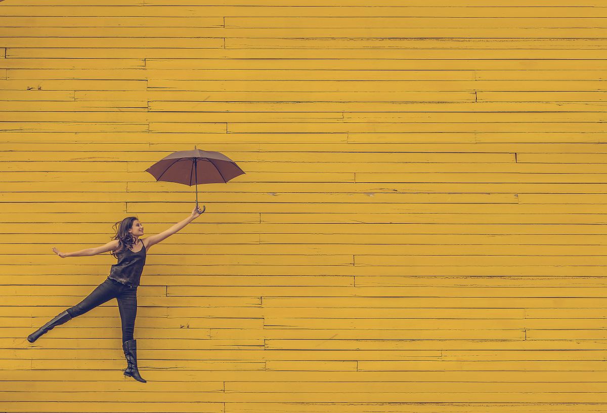 woman holding brown umbrella