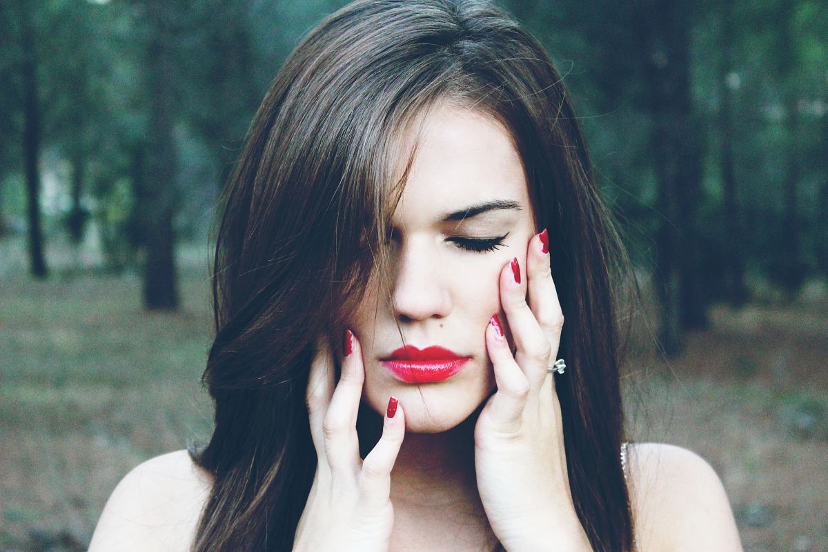 woman holding her face