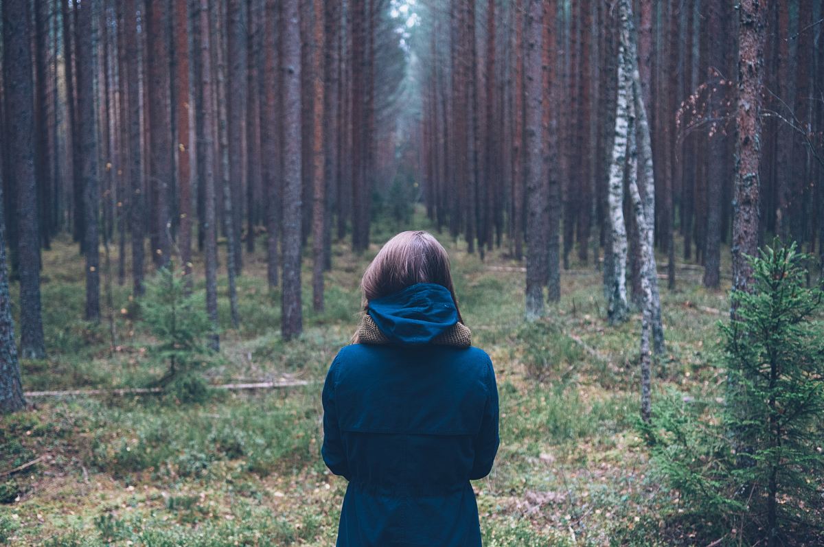 woman in hoodie at forest