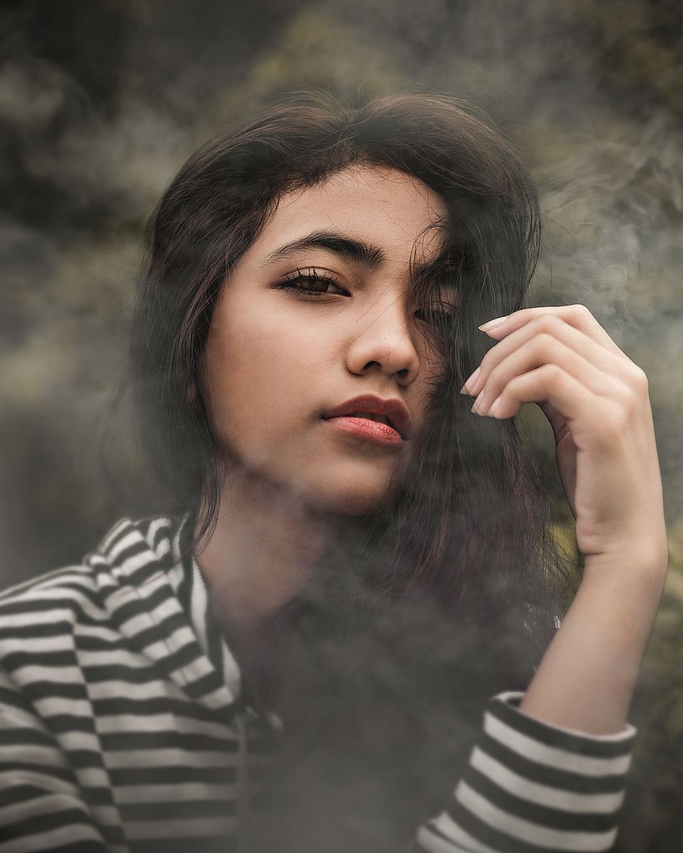 woman in white and black striped pullover top covered with smoke