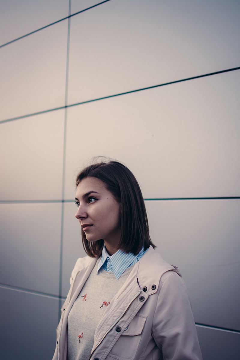 woman in white jacket looking forward
