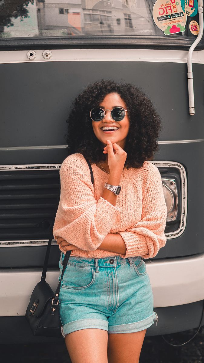 woman leaning on black car front