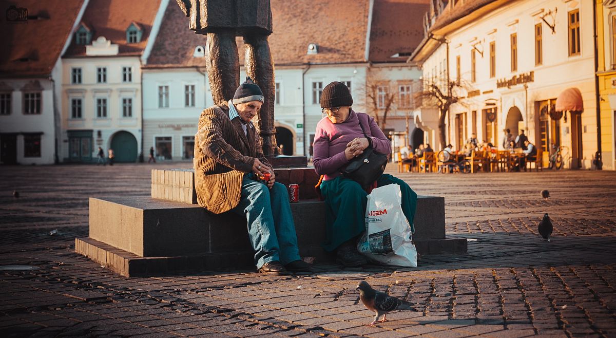 woman sitting beside men near statue