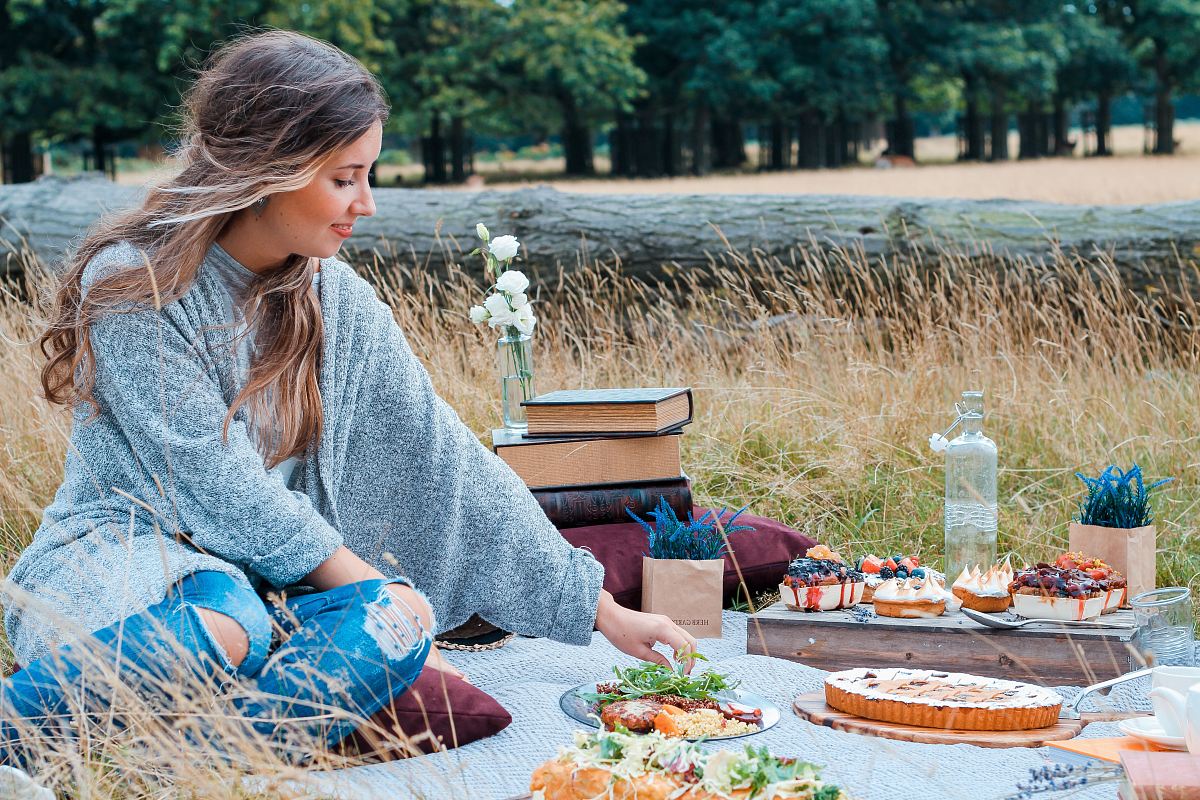 woman sitting on picnic mat