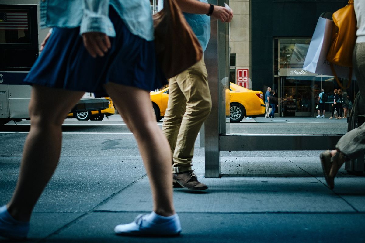 woman walking on road sideways