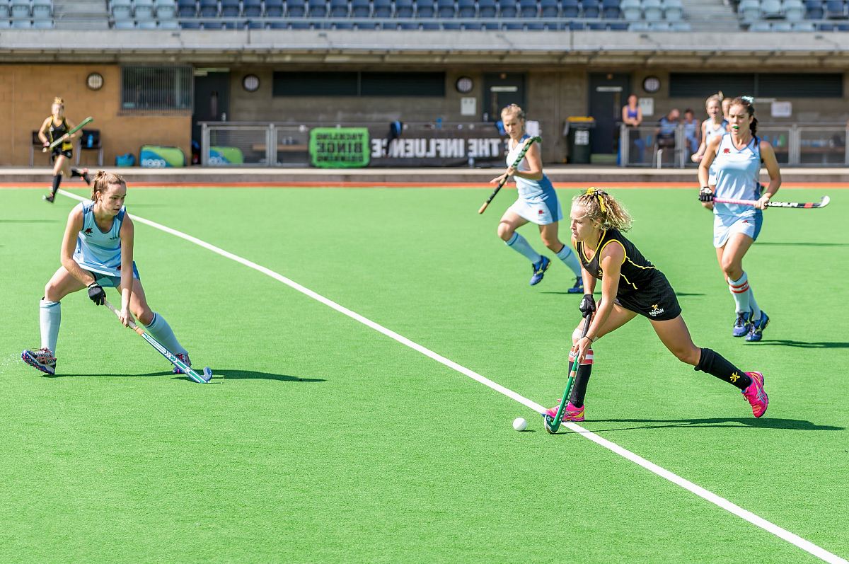woman wearing black jersey playing on field