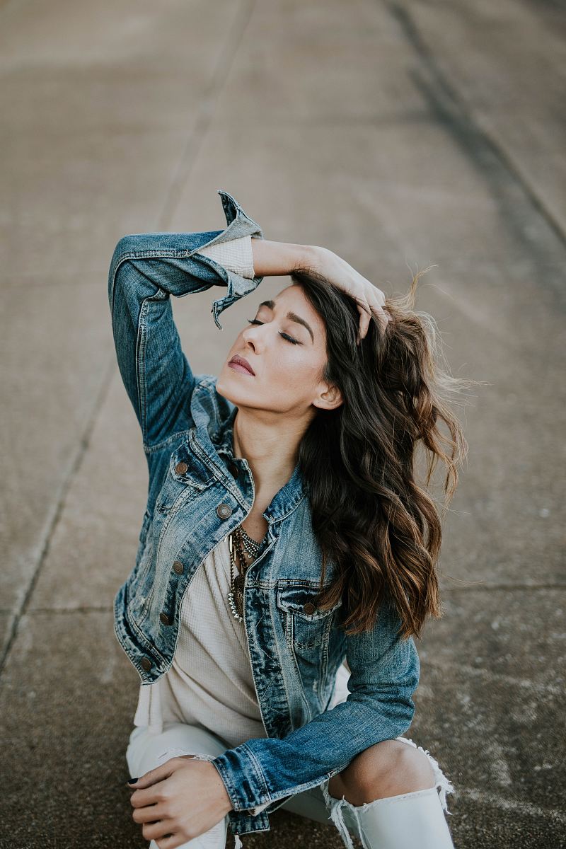 woman wearing blue denim jacket