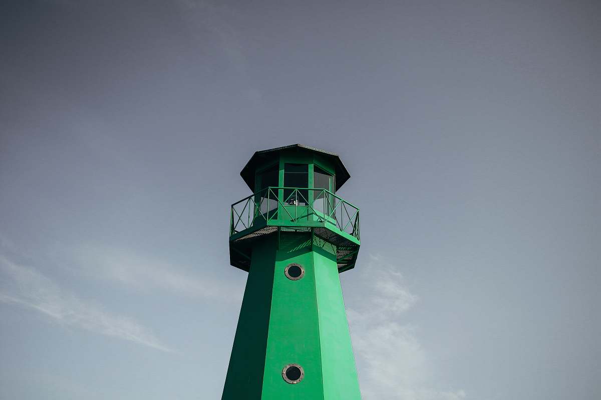 lighthouse green lighthouse under cloudy sky during daytime gdańsk