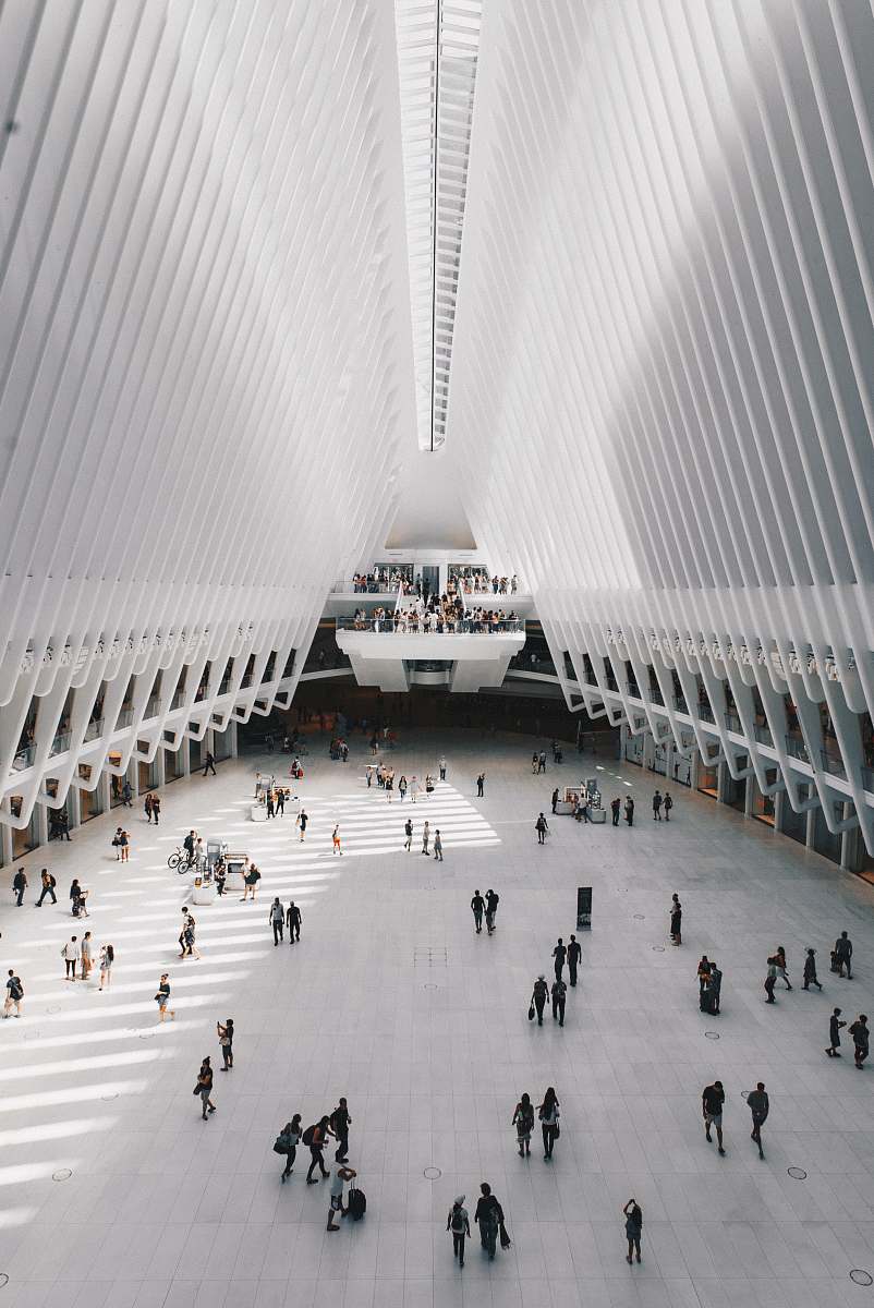 architecture people walking inside white concrete building new york