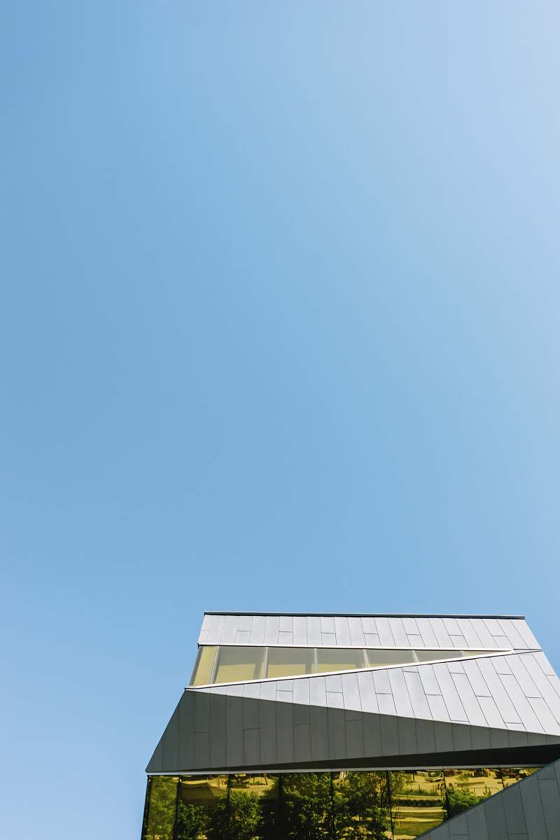 sky low-angle photography of white concrete building under clear blue sky building