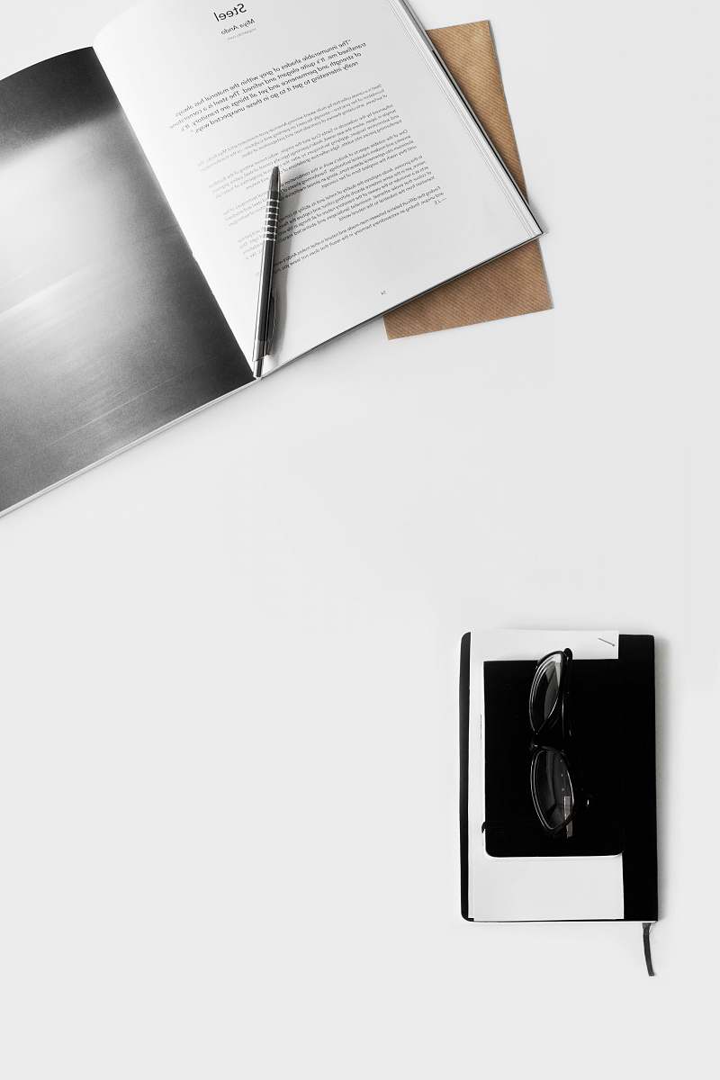 text eyeglasses on book paper