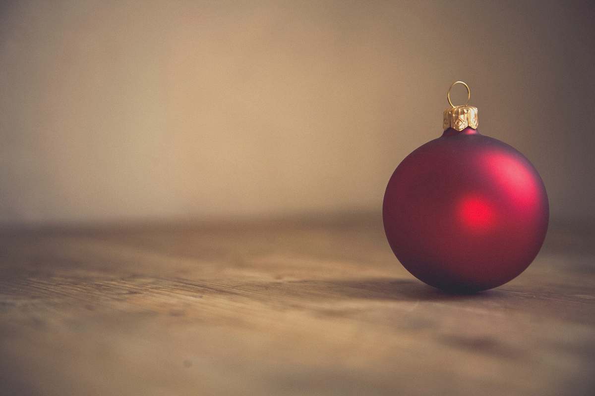 holiday closeup photo of red ball ornament on surface ornament