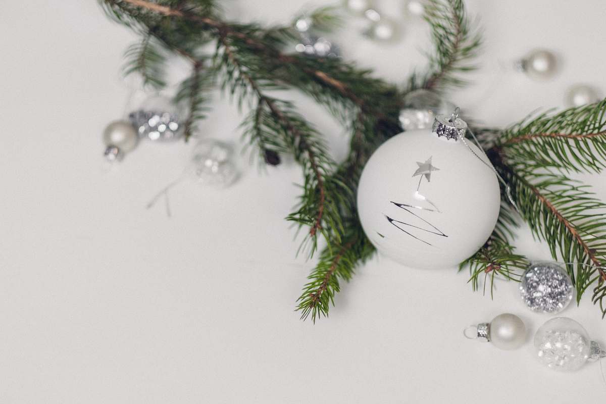 tree white bauble beside garland fir