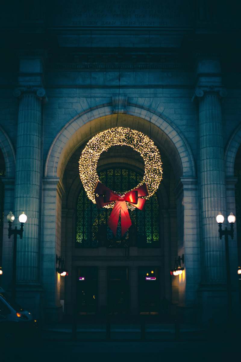 holiday wreath with string lights hanging lights