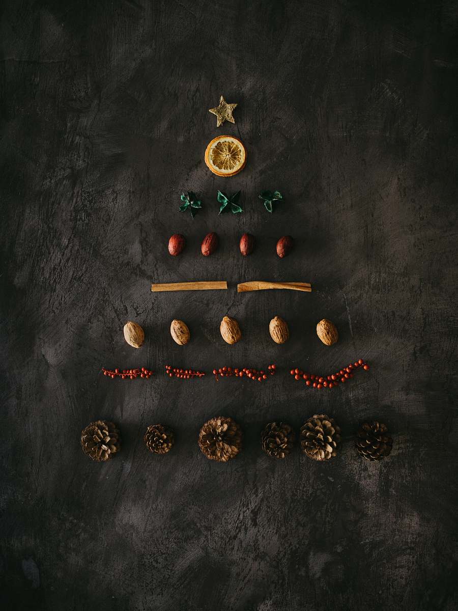 christmas assorted-color ornaments on black surface plant