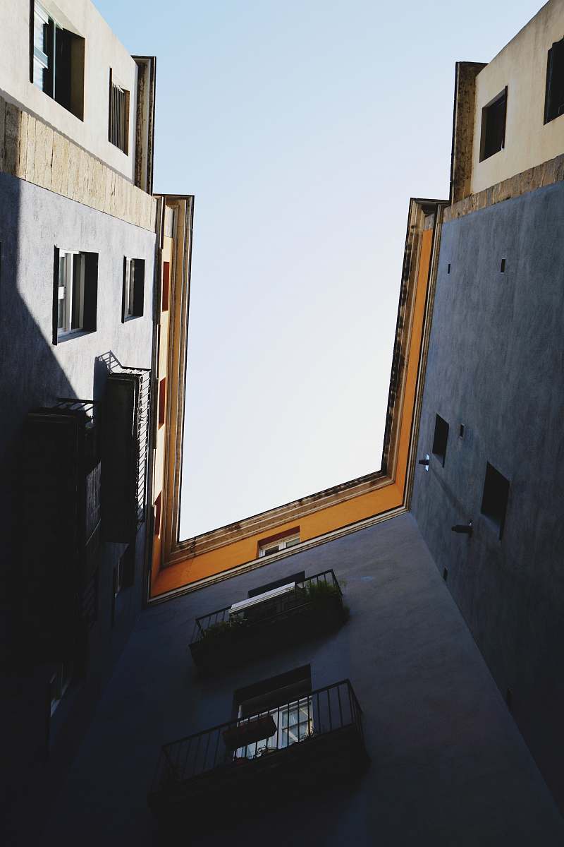 spain low angle photography of gray concrete building sky
