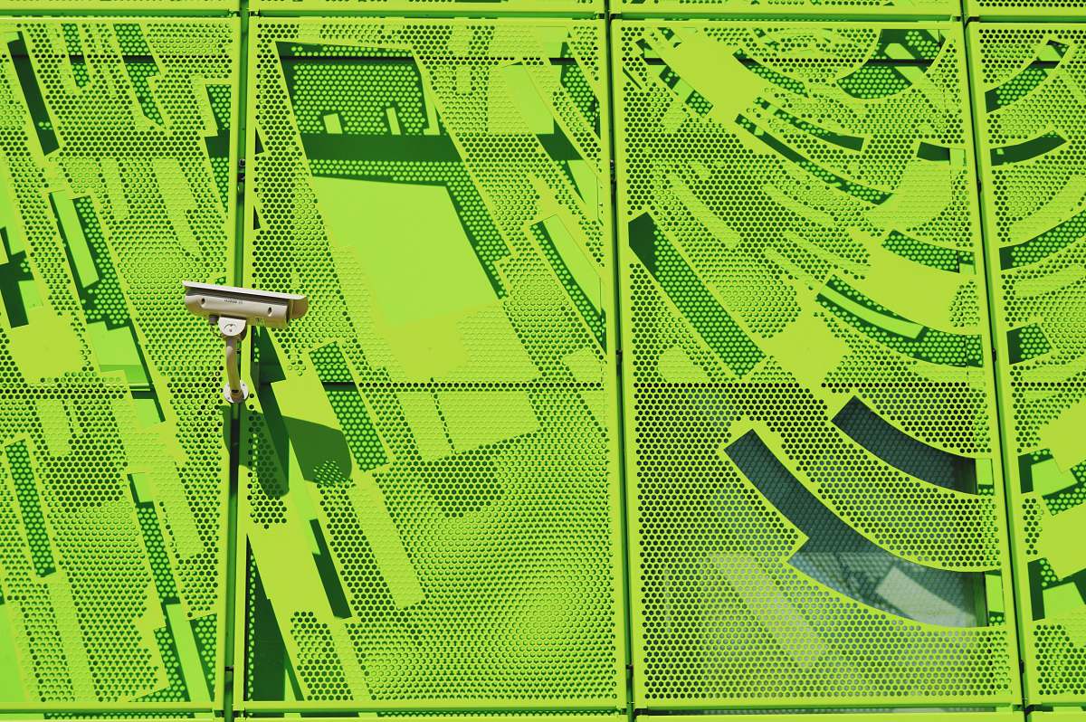 lyon white security camera on green wall france