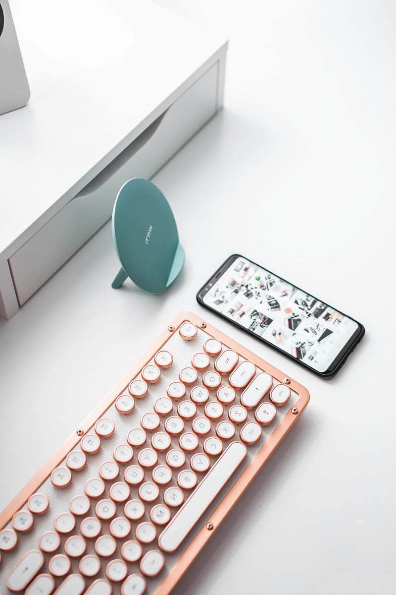 office black smartphone beside computer keyboard timișoara