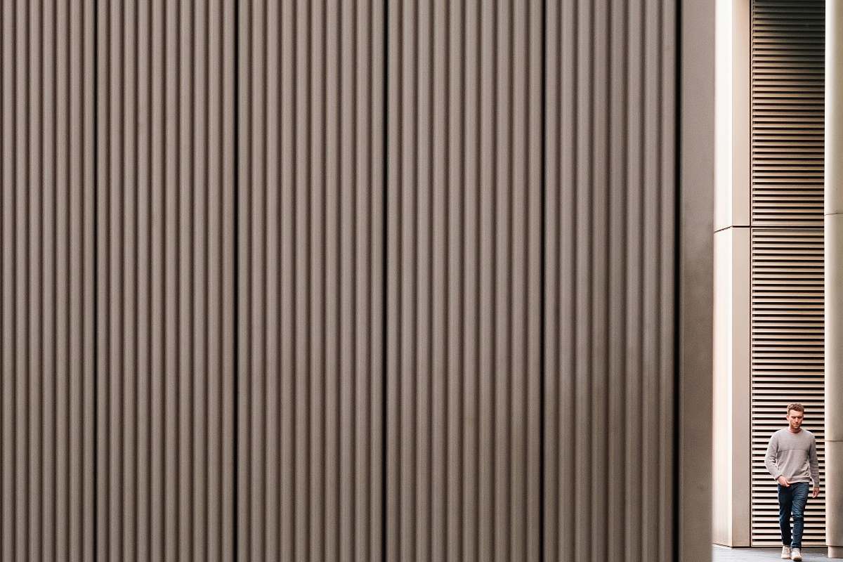 curtain man walking towards gray wall home decor