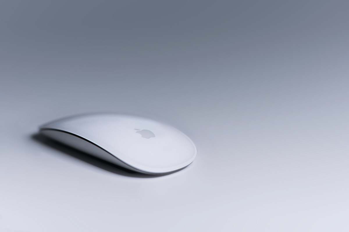 grey Magic Mouse on white surface white